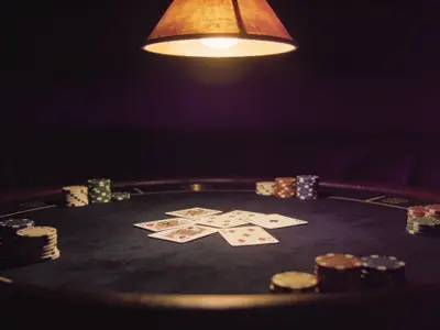 Cards and chips on a dark casino table