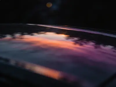 Coloured light reflected on a dark glass surface